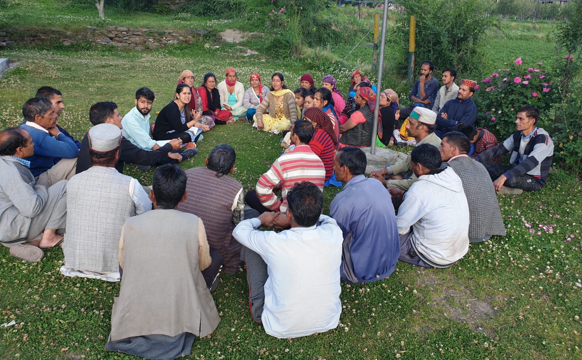 People gathered and discussed, sitting on green grass
