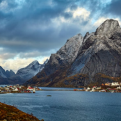 Sea, settlements and grey mountains in Reine, Norway