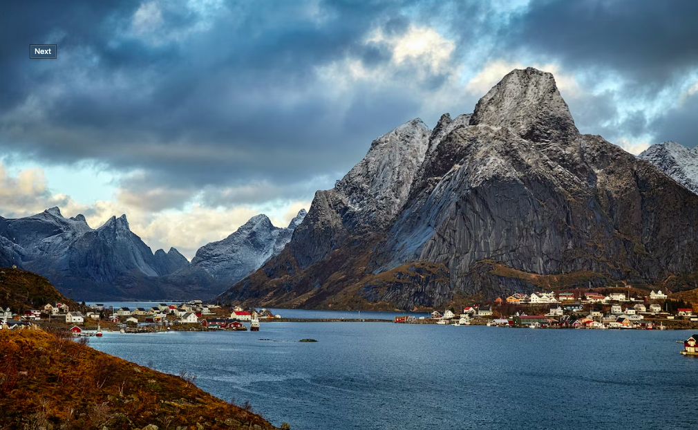 Sea, settlements and grey mountains in Reine, Norway