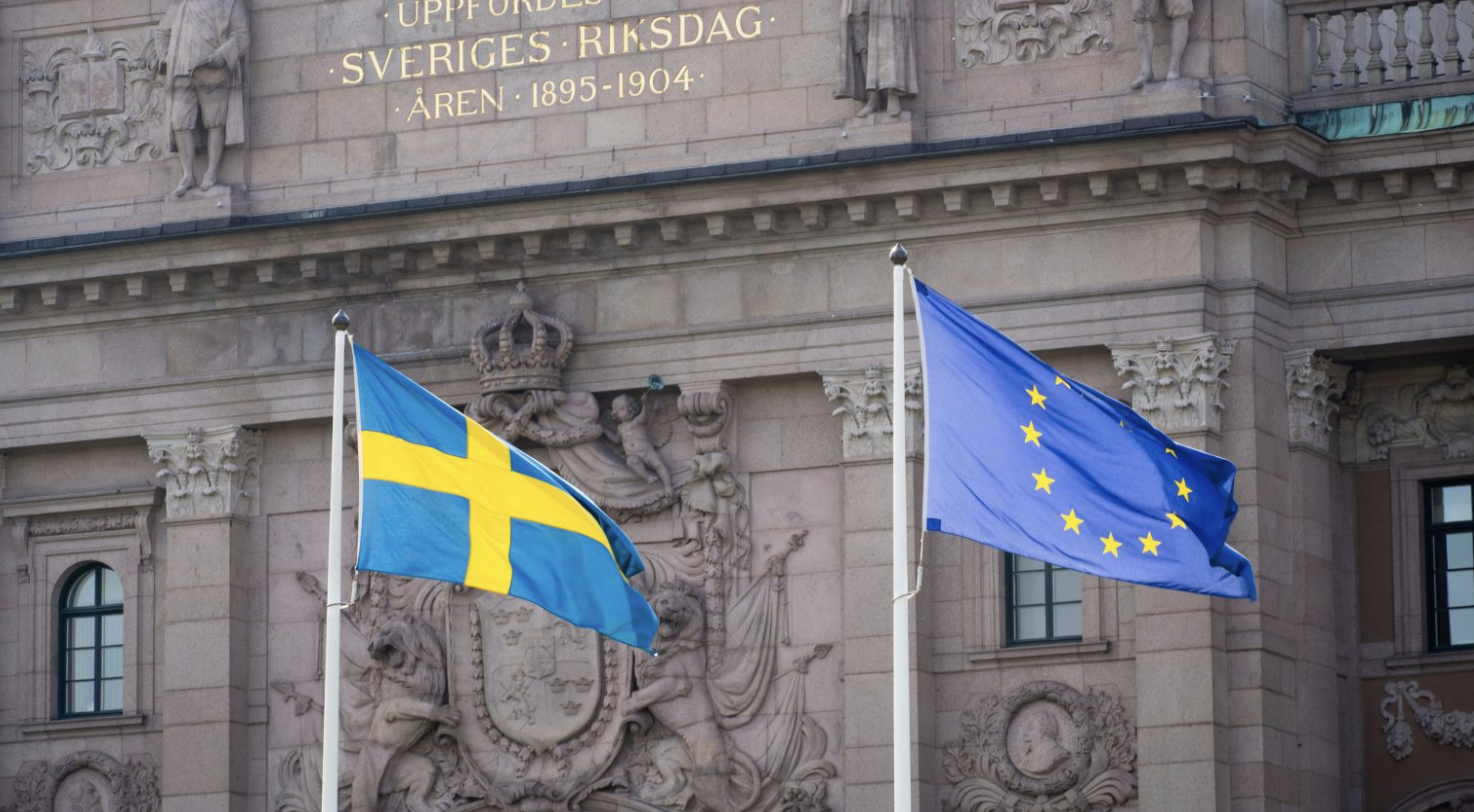 Swedish flag next to the EU flag
